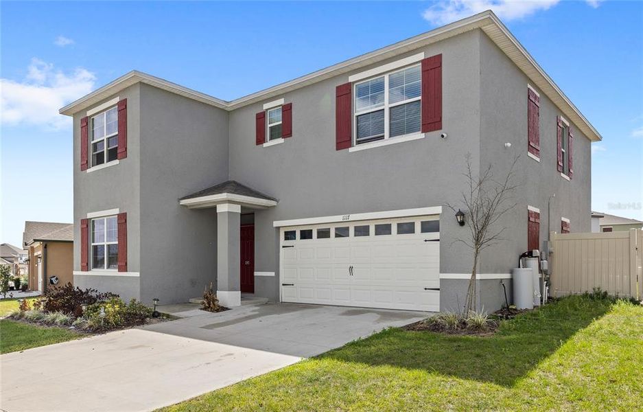 Front exterior of a new home in Eden Hills, Lake Alfred, FL, highlighting curb appeal (Image 26).