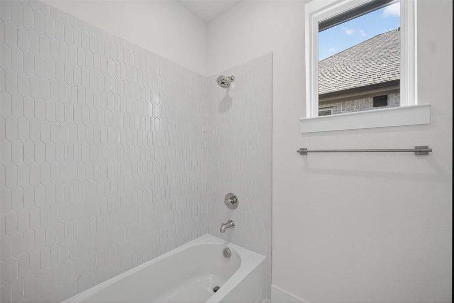 Bathroom featuring shower / bathtub combination Bathroom featuring shower / bathtub combination