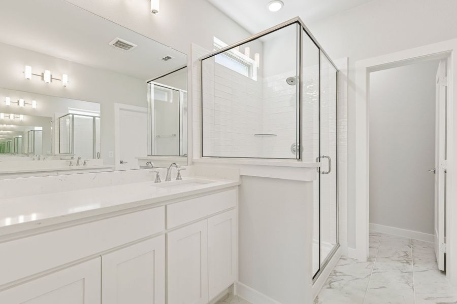 Primary Bathroom in the Masters home plan by Trophy Signature Homes – REPRESENTATIVE PHOTO