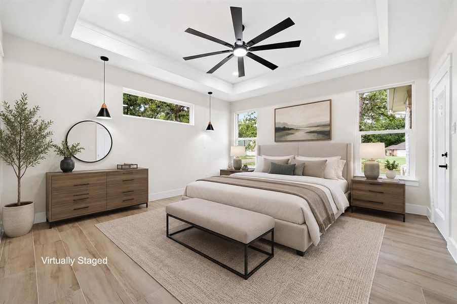 Recessed lighting illuminates a tray ceiling featuring a modern ceiling fan Recessed lighting illuminates a tray ceiling featuring a modern ceiling fan