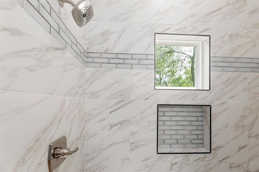 Room details featuring a tile shower