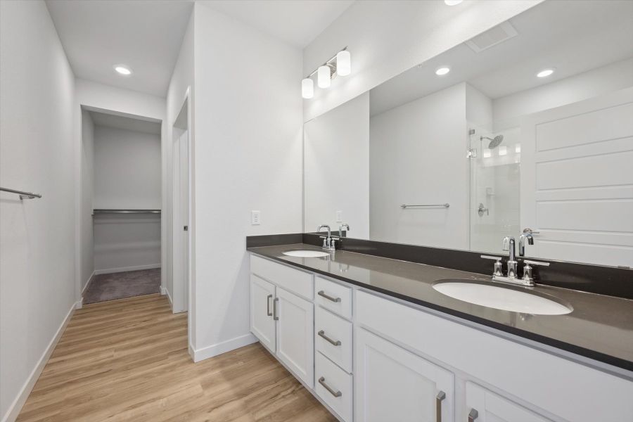 A bathroom with a large mirror. A bathroom with a large mirror.