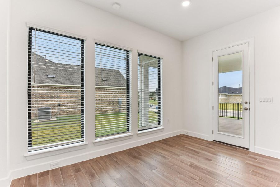 Unfurnished room featuring plenty of natural light, light wood-style flooring, and recessed lighting Unfurnished room featuring plenty of natural light, light wood-style flooring, and recessed lighting