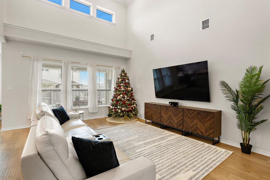 A wall of windows brings in steady natural light and keeps the room connected to the backyard