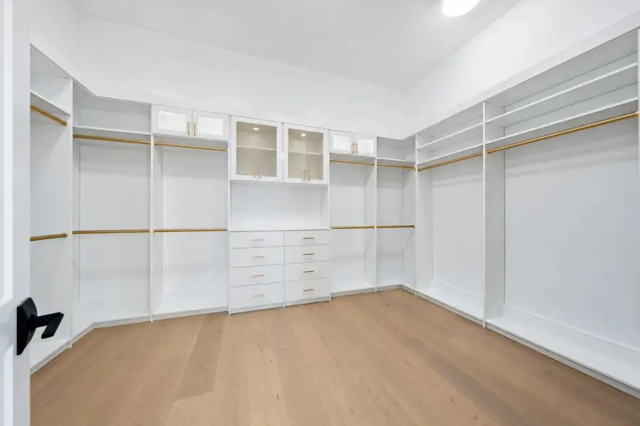 Minimalist White Walk-In Closet with Bra