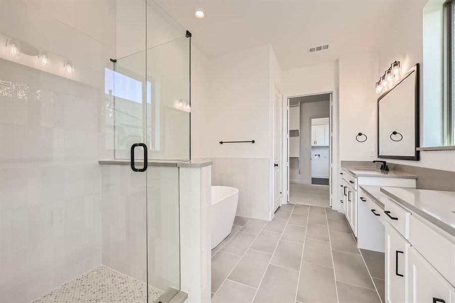 Main bathroom with vanity, tile patterned floors, and plus walk in shower