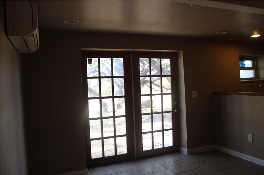 Doorway featuring an AC wall unit, tile patterned floors, and recessed lighting Doorway featuring an AC wall unit, tile patterned floors, and recessed lighting