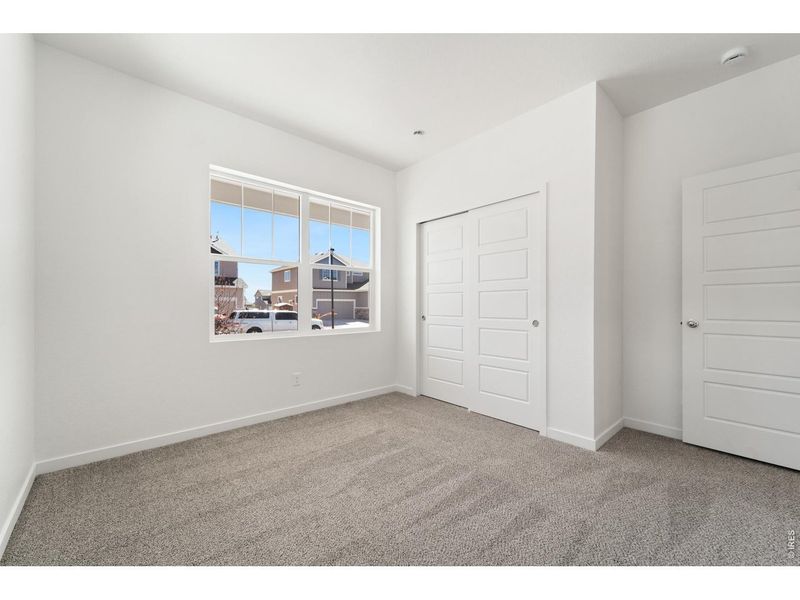 Spacious, unfurnished interior of a new home in Union Colony West, Greeley (Image 12).