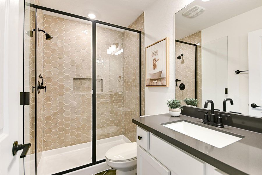 A full bath upstairs features an upgraded walk-in tiled shower and lots of counter space for getting ready.