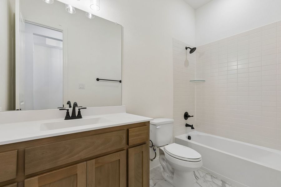Representative furnished interior of a home built from the Pecos by Sandlin Homes in Settler's Glen, New Fairview (Image 12).
