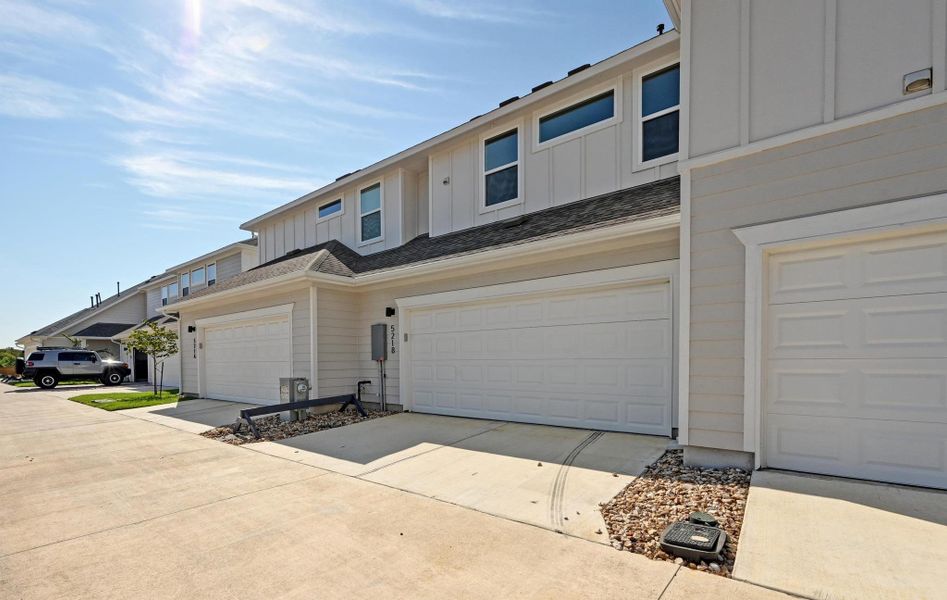 Front exterior of a new home in , Buda, TX, highlighting curb appeal (Image 26).