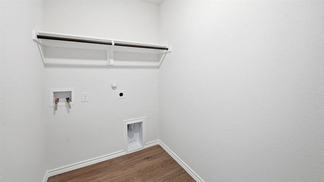 Laundry area featuring dark wood-style floors, gas dryer hookup, hookup for a washing machine, and electric dryer hookup Laundry area featuring dark wood-style floors, gas dryer hookup, hookup for a washing machine, and electric dryer hookup