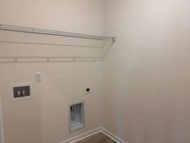 Laundry area with hookup for a washing machine, hookup for an electric dryer, and wood finished floors
