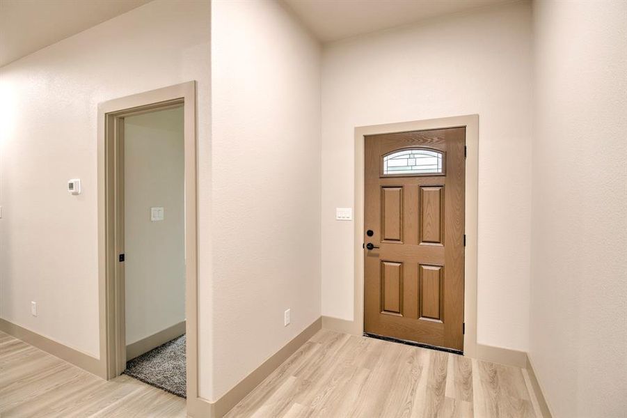 Entrance foyer featuring light wood-style floors and baseboards
