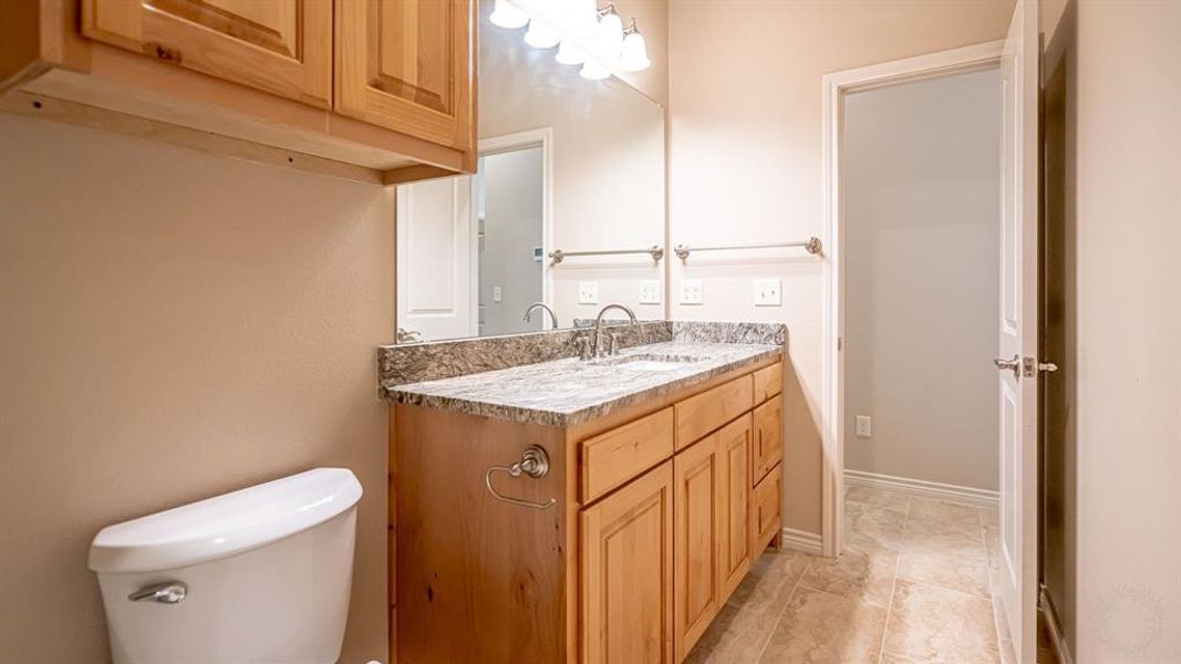 Half bathroom with vanity and toilet