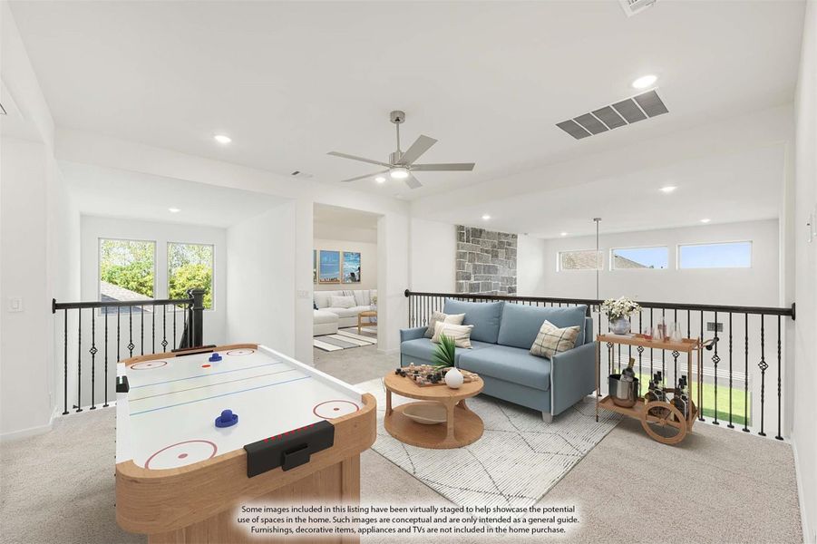 Upstairs game room with air hockey table, blue sofa, ceiling fan, and open railing overlooking lower level