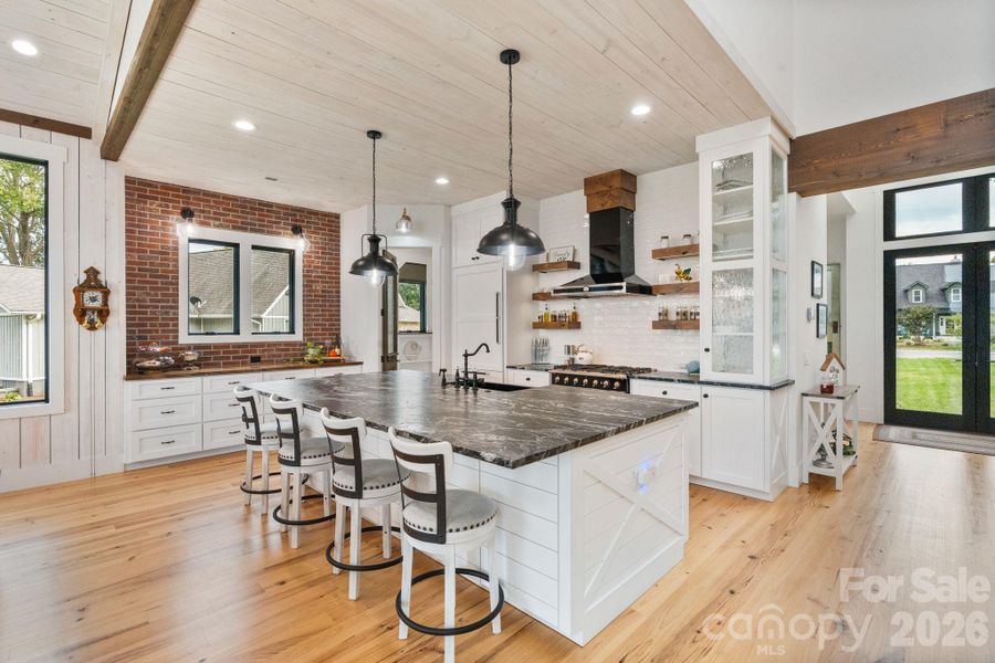 The expansive kitchen is the heart of the home, combines glass, wood, and tile beautifully The expansive kitchen is the heart of the home, combines glass, wood, and tile beautifully