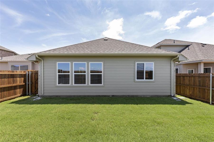 Rear view of house with a lawn