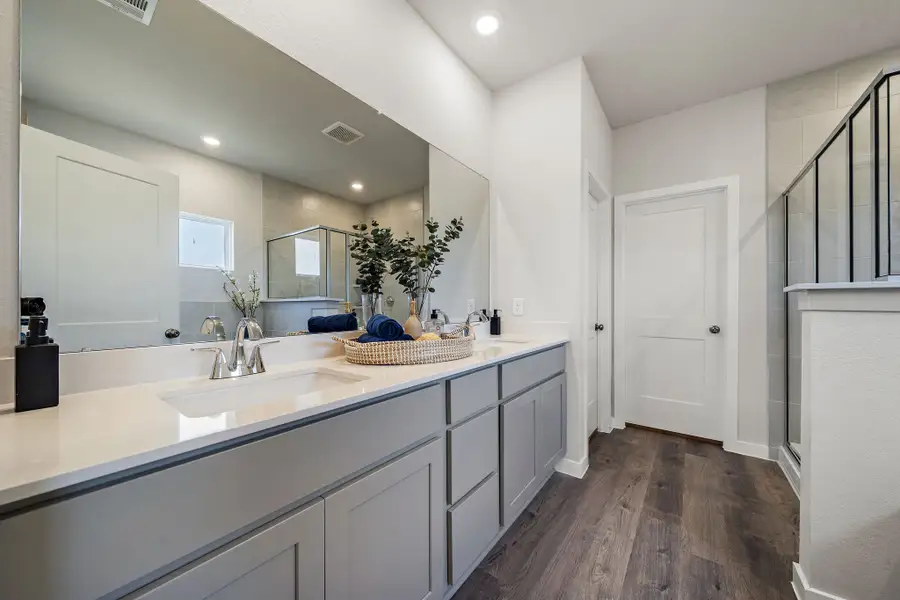 A bathroom with a large mirror.