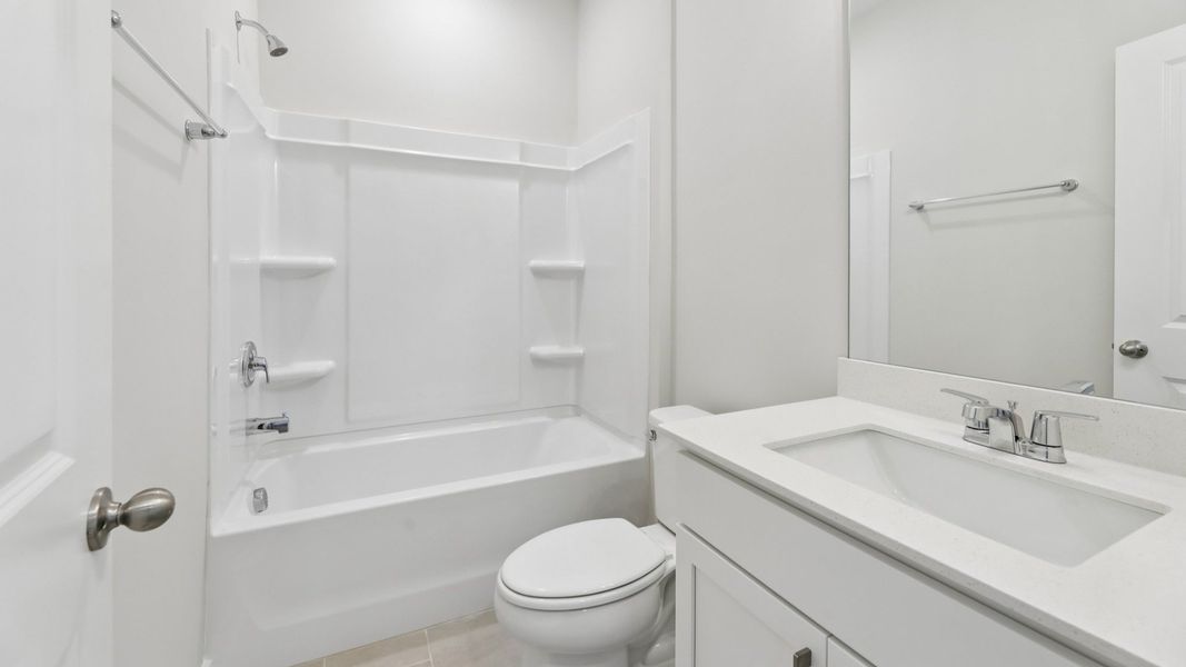 Bathroom with shower and hard surface flooring