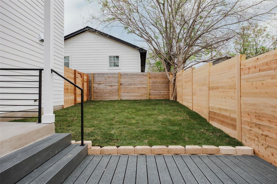 Fenced backyard featuring a wooden deck