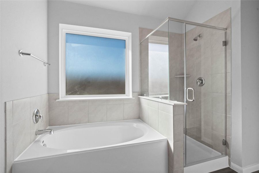 Additional view of the primary bathroom showcases the soaking tub and walk-in shower with window allowing in natural lighting. Additional view of the primary bathroom showcases the soaking tub and walk-in shower with window allowing in natural lighting.