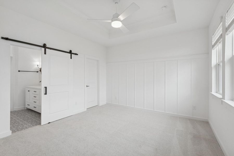 Private primary suite with feature wall