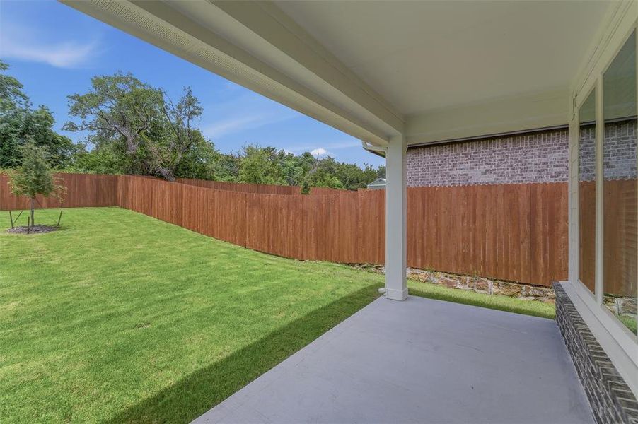 Covered patio featuring a concrete slab and white support columns