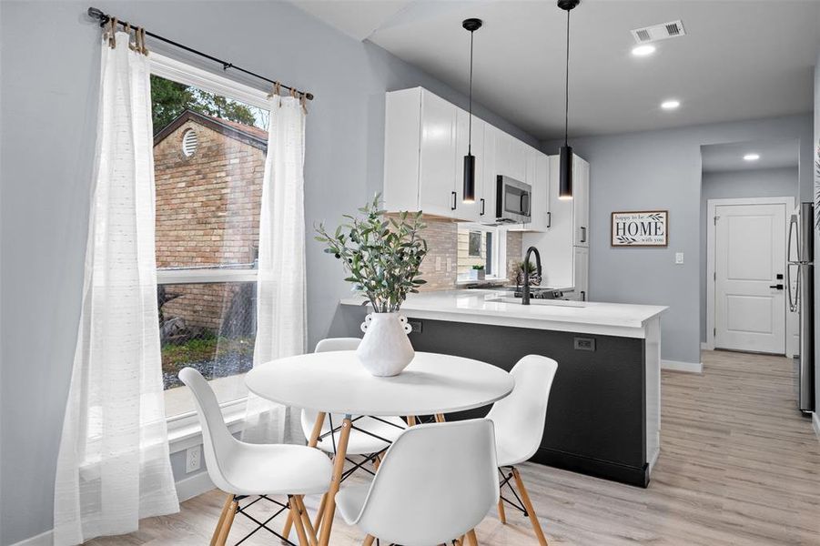 Dining space featuring light wood-type flooring, plenty of natural light, and recessed lighting Dining space featuring light wood-type flooring, plenty of natural light, and recessed lighting