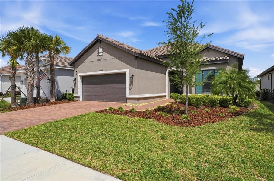 Front exterior of a new home in Esplanade at Artisan Lakes, Palmetto, FL, highlighting curb appeal (Image 22).