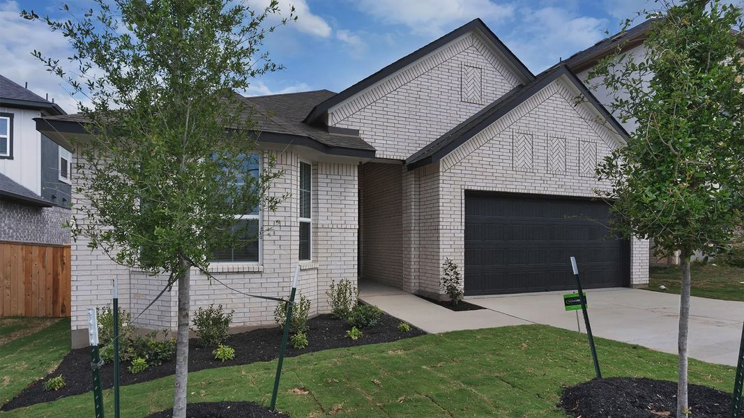 Front exterior of a new home in Lariat, Liberty Hill, TX, highlighting curb appeal (Image 2). Front exterior of a new home in Lariat, Liberty Hill, TX, highlighting curb appeal (Image 2).