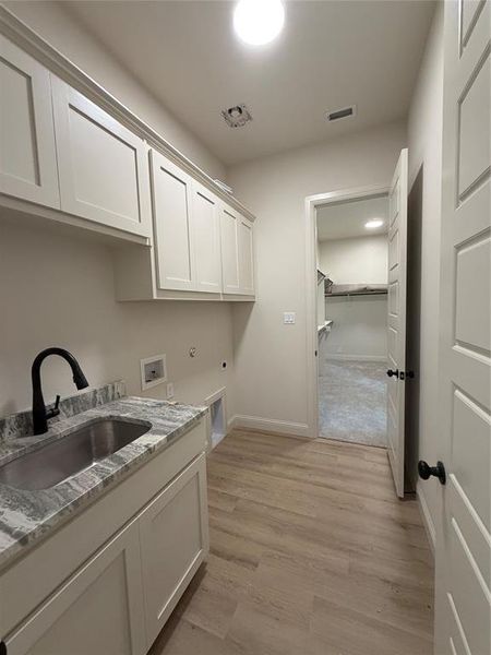 Primary closet conveniently connects to the utility room