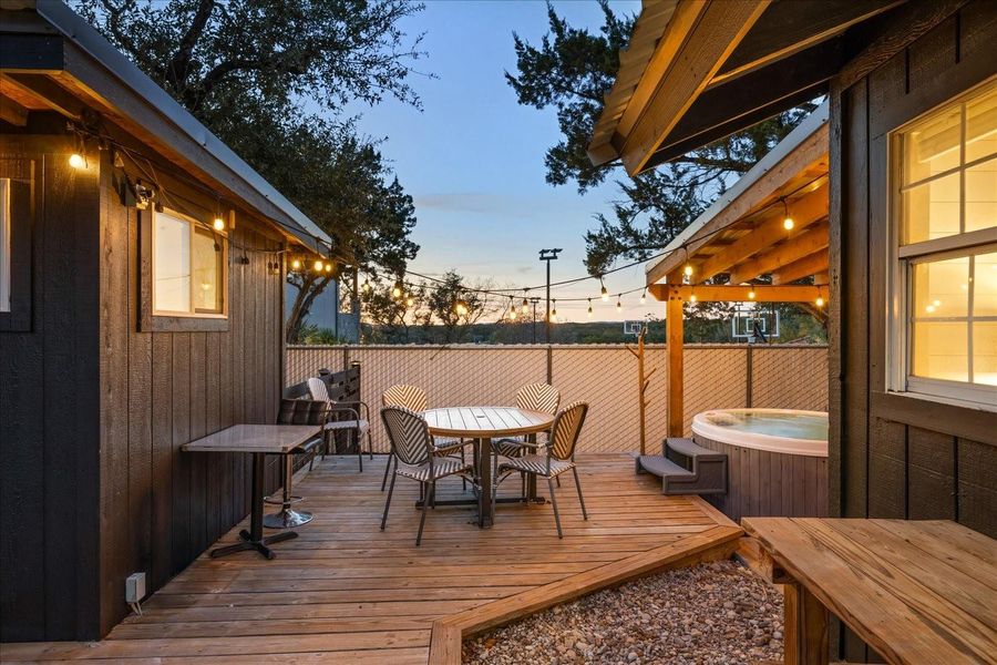 Cabin: View of outdoor dining and hot tub. Office pod on left, cabin on right.