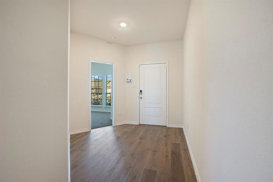 Doorway with hardwood / wood-style flooring