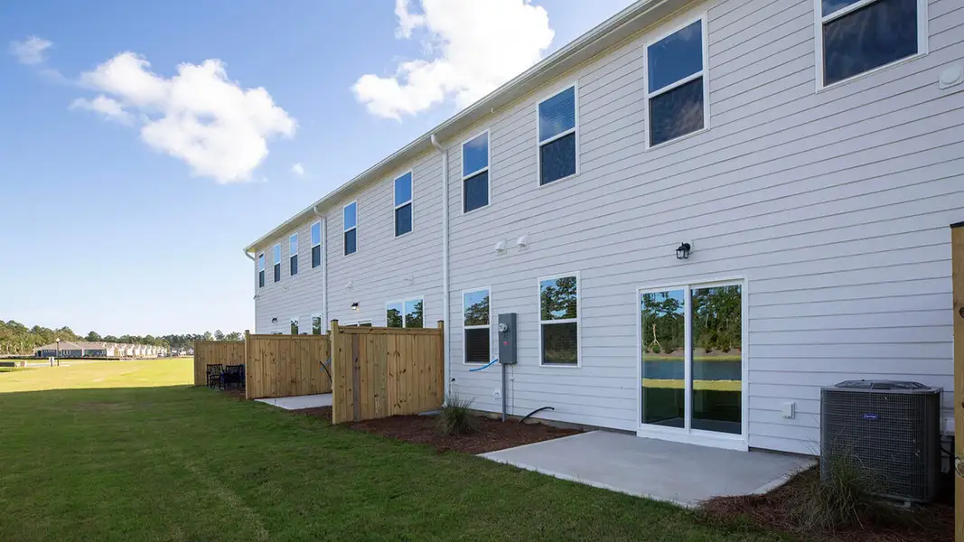 Exterior details and patio area of a home in The Palms at Indigo Preserve Townhomes, Leland (Image 2). Exterior details and patio area of a home in The Palms at Indigo Preserve Townhomes, Leland (Image 2).