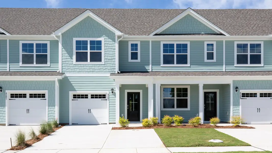 Front exterior of a new home in Indigo Preserve Townhomes, Leland, NC, highlighting curb appeal (Image 1).