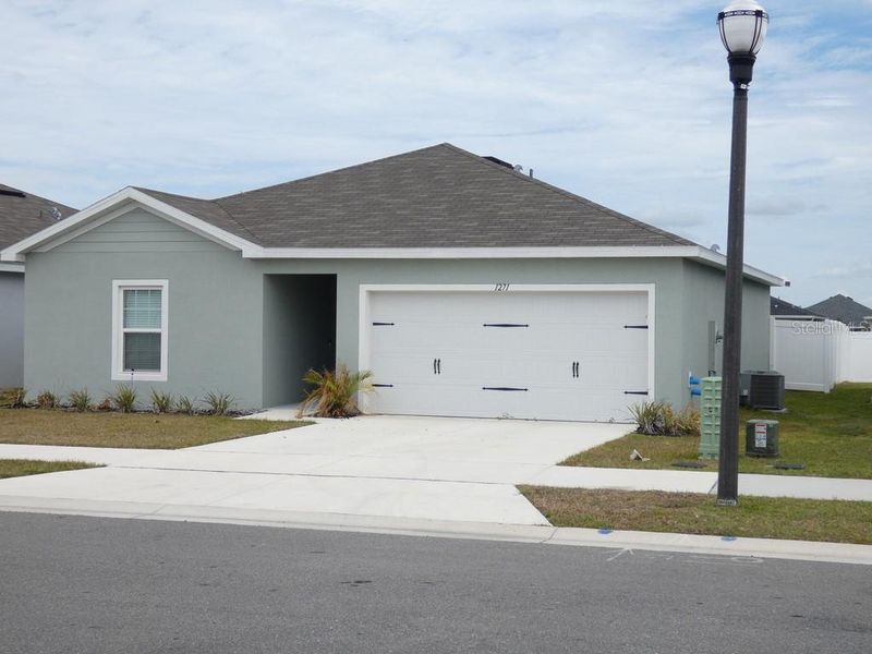 Front exterior of a new home in , Haines City, FL, highlighting curb appeal (Image 25). Front exterior of a new home in , Haines City, FL, highlighting curb appeal (Image 25).