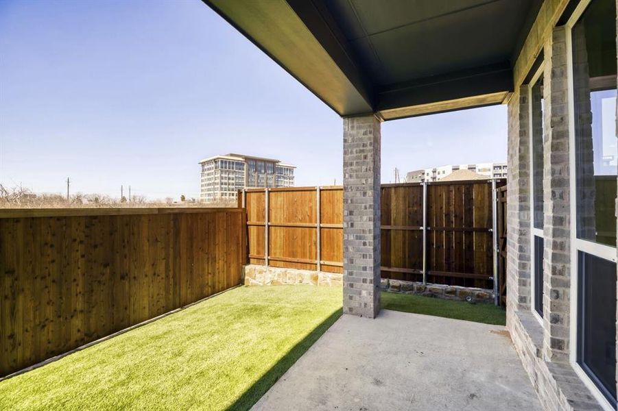 Fenced backyard with a patio area