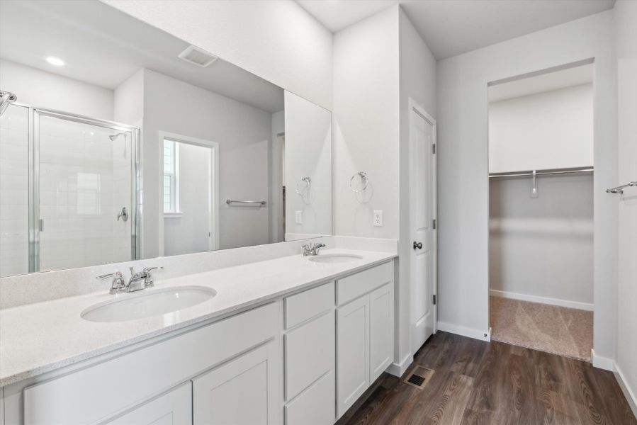 A bathroom with a large mirror.
