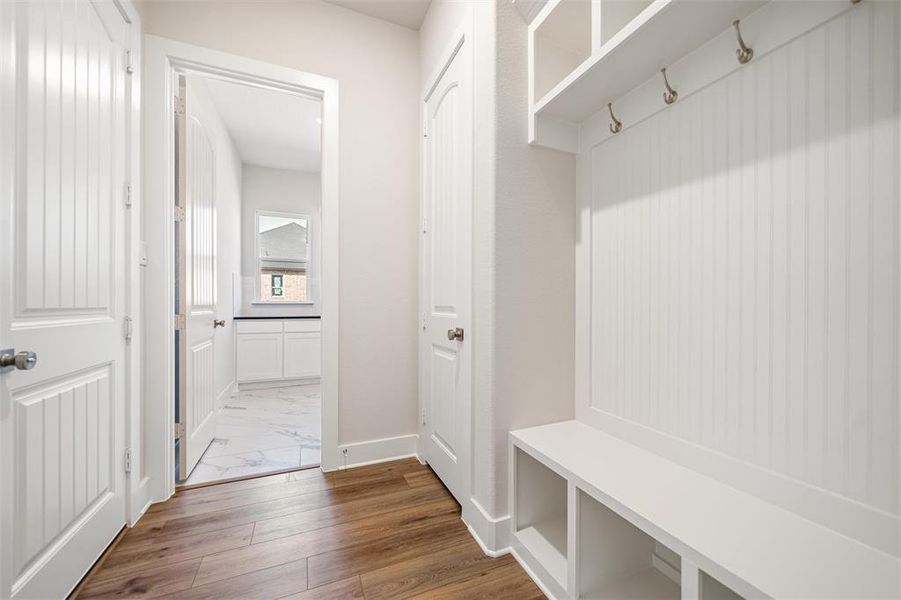 Mudroom featuring baseboards and dark wood-style flooring Mudroom featuring baseboards and dark wood-style flooring