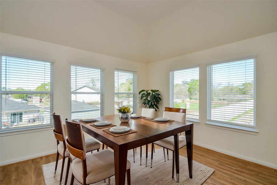 Step into this lovely dining area with large windows that shower the room in sunlight.