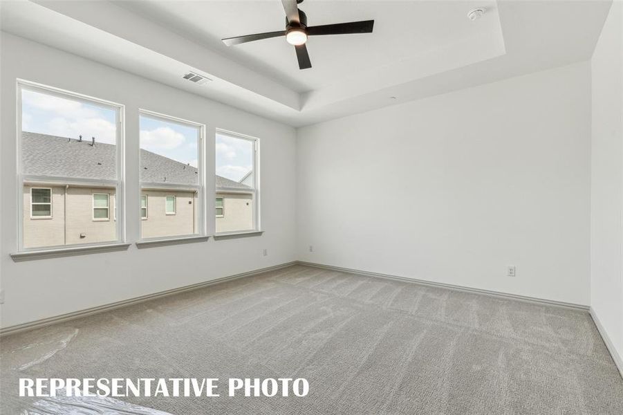 This dreamy owner's suite features high ceilings and tons of natural light.  REPRESENTATIVE PHOTO
