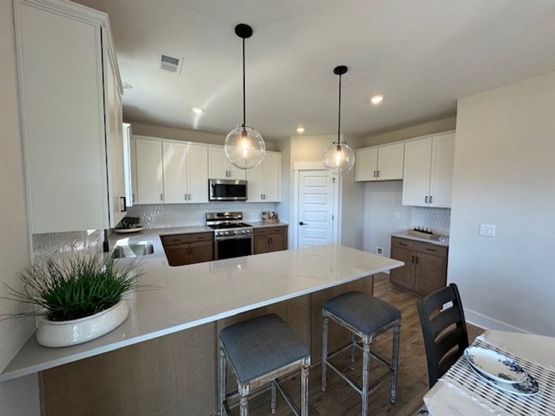 This kitchen features a sleek island and modern ap