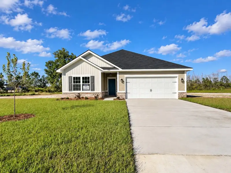 Front exterior of a new home in Tibet Road at Sassafras, Allenhurst, GA, highlighting curb appeal (Image 1). Front exterior of a new home in Tibet Road at Sassafras, Allenhurst, GA, highlighting curb appeal (Image 1).