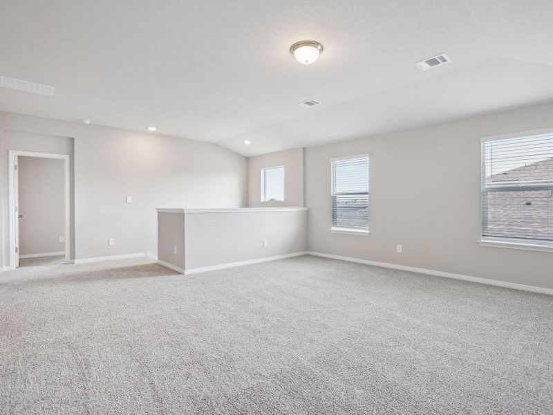Spare room featuring vaulted ceiling, light colored carpet, baseboards, and recessed lighting Spare room featuring vaulted ceiling, light colored carpet, baseboards, and recessed lighting