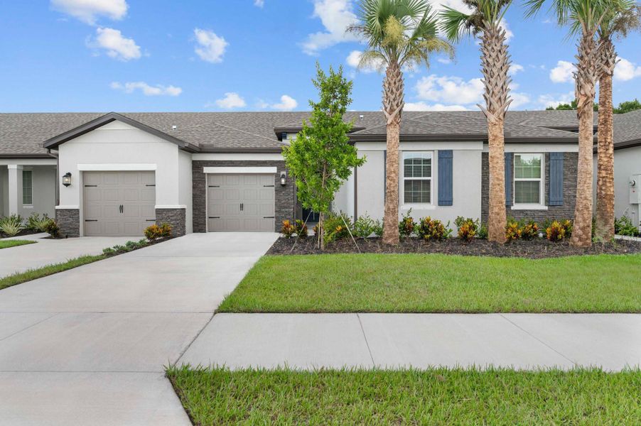 Front exterior of a new home in Celebration Pointe, Fort Pierce, FL, highlighting curb appeal (Image 2).