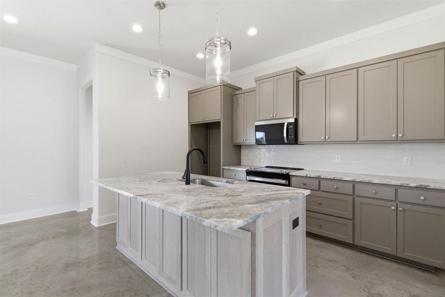 Kitchen with gray cabinets, concrete flooring, tasteful backsplash, appliances with stainless steel finishes, and pendant lighting