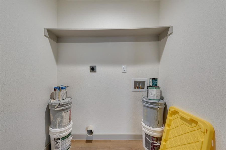 Clothes washing area featuring hardwood / wood-style floors, hookup for a washing machine, and hookup for an electric dryer