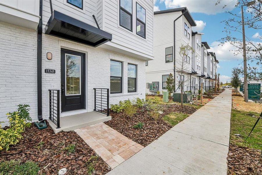 Exterior details and patio area of a home in Parkview at Hamlin, Winter Garden (Image 26).