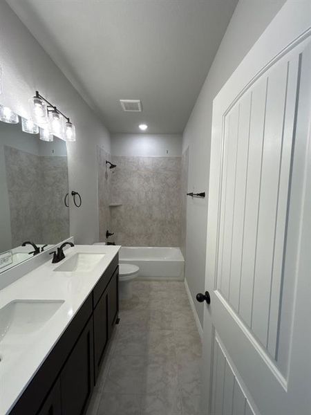 Double vanity with white countertops, dark wood-finish cabinetry, and matte black fixtures Double vanity with white countertops, dark wood-finish cabinetry, and matte black fixtures
